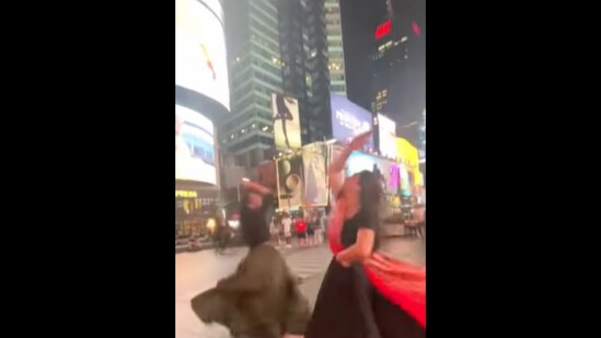 A screengrab from the video that shows the two women doing Garba at Times Square. (Instagram/@_misthel)