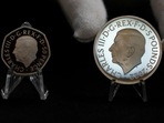 Two new coins bearing official coinage portrait of King Charles III, on the left is the new 50 pence coin, and right is the new 5 pound commemorative coin, which will be among the first coins to bear the new king's head.(AP) Two new coins bearing official coinage portrait of King Charles III, on the left is the new 50 pence coin, and right is the new 5 pound commemorative coin, which will be among the first coins to bear the new king's head.(AP)