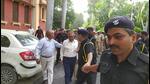 AU proctor prof Harsh Kumar (centre) being escorted by security personnel on campus on Thursday. . (Ht photo) AU proctor prof Harsh Kumar (centre) being escorted by security personnel on campus on Thursday. . (Ht photo)