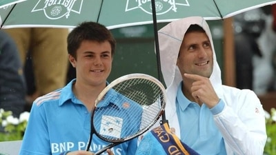 Serbia's Novak Djokovic (R) shares a laugh with a ball boy during his French tennis Open first round match at the Roland Garros stadium in Paris (AFP PHOTO) Serbia's Novak Djokovic (R) shares a laugh with a ball boy during his French tennis Open first round match at the Roland Garros stadium in Paris (AFP PHOTO)