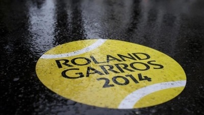 A rain-covered sticker of a tennis ball shows the way to walk towards the French Open tennis tournament outside the Roland Garros stadium, in Paris. A light drizzle is expected top cause delays in the first round matches. (AP Photo/Peter Dejong) A rain-covered sticker of a tennis ball shows the way to walk towards the French Open tennis tournament outside the Roland Garros stadium, in Paris. A light drizzle is expected top cause delays in the first round matches. (AP Photo/Peter Dejong)
