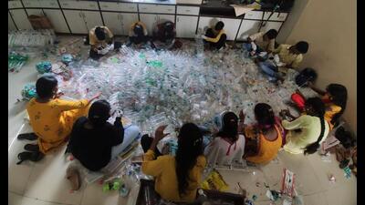 Children of Thane ragpickers during an activity session with plastic bottles to convey the message of save the environment. (HT PHOTO)