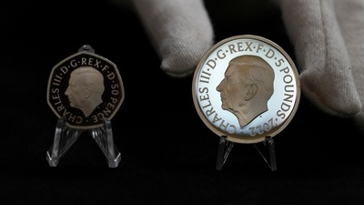 Two new coins bearing official coinage portrait of King Charles III, on the left is the new 50 pence coin, and right is the new 5 pound commemorative coin, which will be among the first coins to bear the new king's head. (AP) Two new coins bearing official coinage portrait of King Charles III, on the left is the new 50 pence coin, and right is the new 5 pound commemorative coin, which will be among the first coins to bear the new king's head. (AP)
