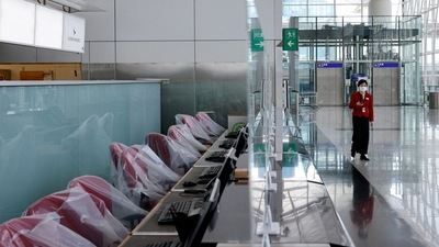 Covid In Hong Kong: A crew member of Cathay Pacific walks at the Hong Kong International Airport Departure Hall. (Reuters)