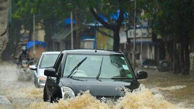 People--drive-through-a-flooded-street-during-rain-showers-in-Mumbai-AFP-Photo People--drive-through-a-flooded-street-during-rain-showers-in-Mumbai-AFP-Photo
