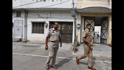 Police outside the house of the accused cop and his live-in partner at New Prem Nagar in Ghumar Mandi, Ludhiana, on Thursday. (Gurpreet Singh/HT)