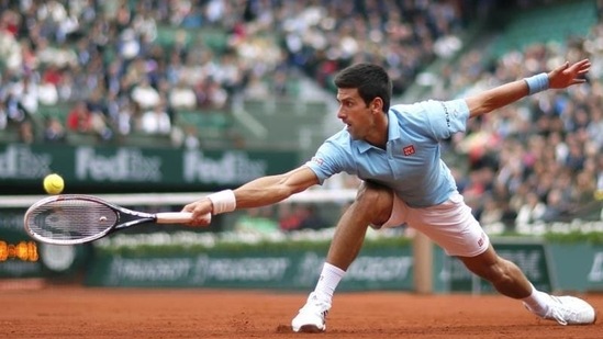 Novak Djokovic of Serbia hits a return to Joao Sousa of Portugal during their men's singles match at the French Open tennis tournament at the Roland Garros stadium (REUTERS Photo)