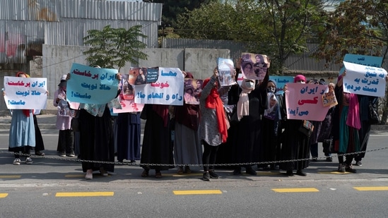 Iran Anti-Hijab Protests: Afghan women hold placards as they take part in a protest in front of the Iranian embassy in Kabul.(AFP)