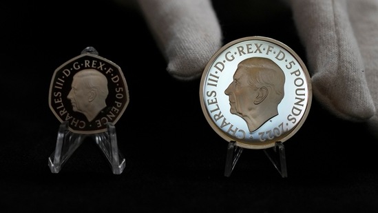 Two new coins bearing official coinage portrait of King Charles III, on the left is the new 50 pence coin, and right is the new 5 pound commemorative coin, which will be among the first coins to bear the new king's head.(AP) Two new coins bearing official coinage portrait of King Charles III, on the left is the new 50 pence coin, and right is the new 5 pound commemorative coin, which will be among the first coins to bear the new king's head.(AP)