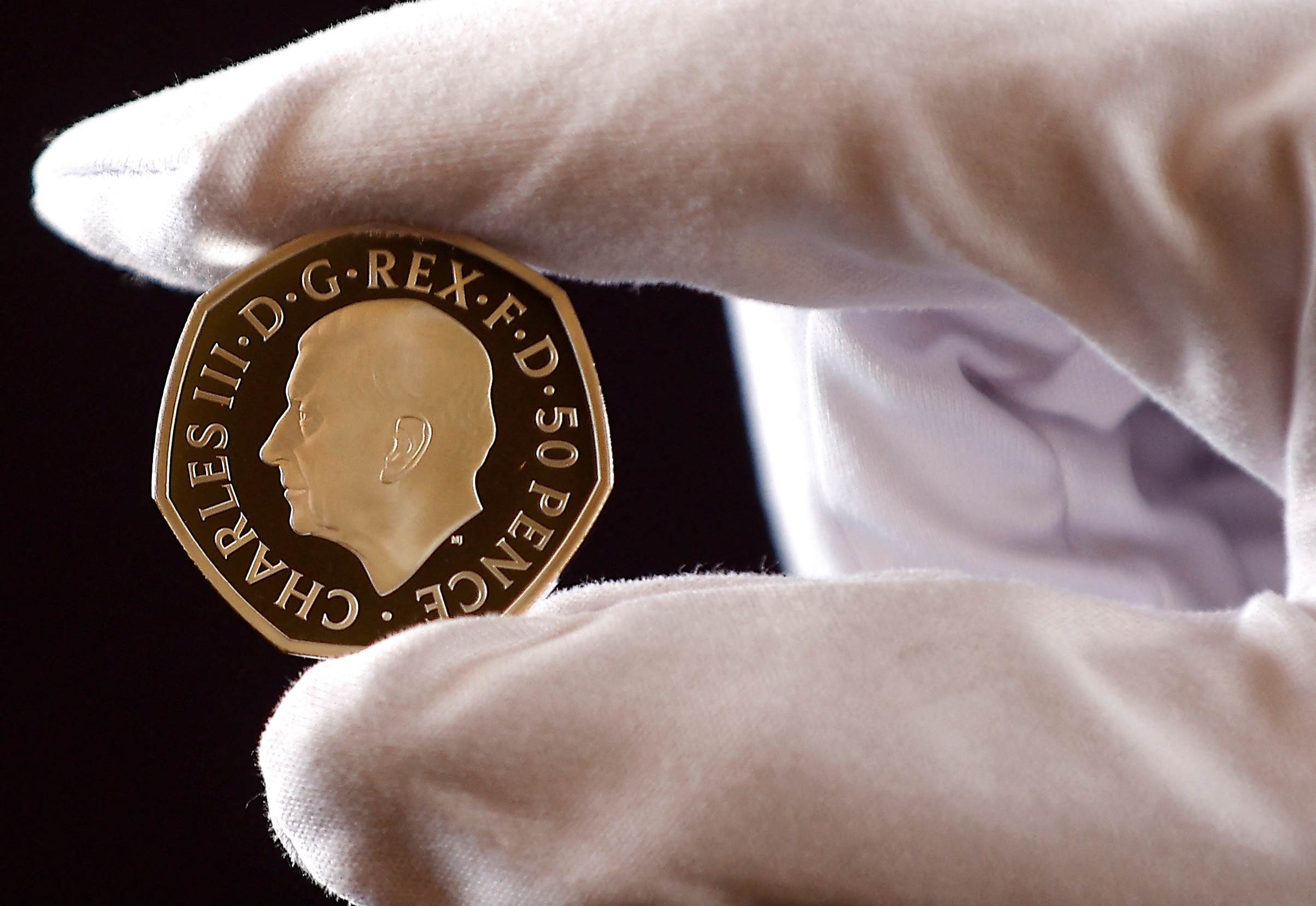 The official coin effigy of Britain’s King Charles III is seen on a 50 pence coin, unveiled by The Royal Mint, in London. (REUTERS)