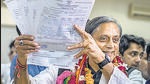 Former Union minister Shashi Tharoor shows his documents as he files his nomination papers for Congress party president election at AICC headquarters in New Delhi on Friday. (AP) Former Union minister Shashi Tharoor shows his documents as he files his nomination papers for Congress party president election at AICC headquarters in New Delhi on Friday. (AP)