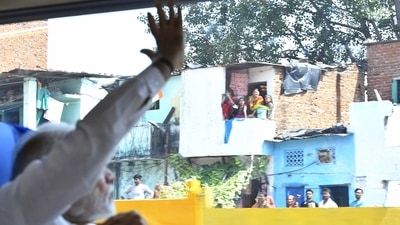 Prime Minister Narendra Modi waves at the public during his ride in the Vande Bharat Express. (ANI) Prime Minister Narendra Modi waves at the public during his ride in the Vande Bharat Express. (ANI)