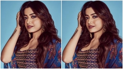 Rashmika decked up in an embellished blue and yellow blouse with a plunging neckline. She further teamed it with a long flowy bright blue silk skirt. Rashmika added the necessary pop of colours in a blue silk oversized shrug with floral patterns. (Instagram/@rashmika_mandanna) Rashmika decked up in an embellished blue and yellow blouse with a plunging neckline. She further teamed it with a long flowy bright blue silk skirt. Rashmika added the necessary pop of colours in a blue silk oversized shrug with floral patterns. (Instagram/@rashmika_mandanna)