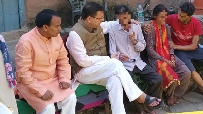 Uttarakhand CM Pushkar Singh Dhami meets parents and relatives of 19-year-old resort receptionist at their residence in Dobh Srikot village in Pauri district. (ANI)