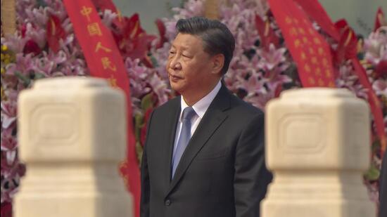 Chinese President Xi Jinping walks past floral bouquets during a ceremony to mark Martyr's Day at the Monument to the People's Heroes at Tiananmen Square in Beijing, on Friday. (AP)