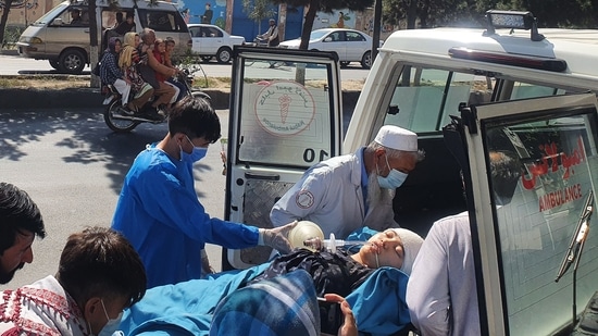 Relatives and medical staff shift a wounded girl from an ambulance outside a hospital in Kabul on September 30, 2022, following a blast at a learning centre in the Dasht-e-Barchi area of Afghanistan's capital. (Photo by AFP)