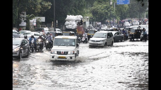 Waterlogging at Mitra Mandal Chowk after heavy rainfall in Pune on Friday. (HT PHOTO)
