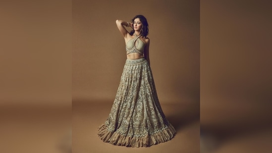 Ananya Panday's set comes with a halter cut-out tie-up blouse, a heavily embellished lehenga and a dupatta.(Instagram/@ananyapanday)