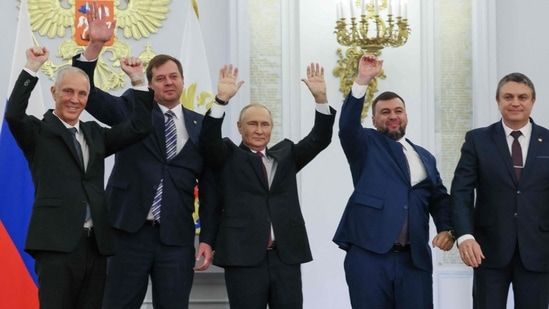 The Moscow-appointed heads of the newly annexed Ukraine regions with Russian President Vladimir Putin (centre), at the Kremlin in Moscow on September 30, 2022. (Photo by Mikhail METZEL/SPUTNIK/AFP)