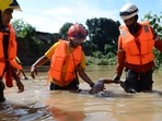 Venezuela Floods: Members of the Civil Protection hold a deceased man after a flood in Barquisimeto, Lara state, Venezuela. Venezuela Floods: Members of the Civil Protection hold a deceased man after a flood in Barquisimeto, Lara state, Venezuela.