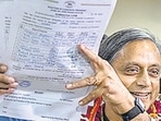 Former Union minister Shashi Tharoor shows his documents as he files his nomination papers for Congress party president election at AICC headquarters in New Delhi on Friday. (AP)