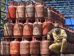 A worker sits inside a lorry, stacked with LPG cylinders . (PTI file) A worker sits inside a lorry, stacked with LPG cylinders . (PTI file)
