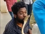 A reptile expert rescued a cobra in Bhadravathi and went to kiss it, when he got bit.((Screengrab of Twitter video)) A reptile expert rescued a cobra in Bhadravathi and went to kiss it, when he got bit.((Screengrab of Twitter video))