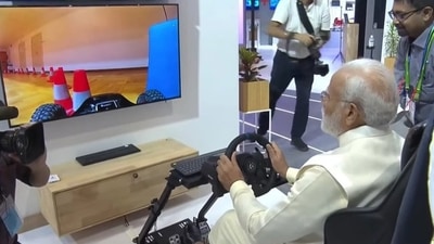 PM Modi test-driving a car in Europe sitting at Pragati Maidan through 5G technology on Saturday.&nbsp;