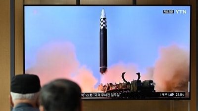 North Korea Ballistic Missile: People watch a television screen showing a news broadcast with file footage of a North Korean missile test. (AFP File) North Korea Ballistic Missile: People watch a television screen showing a news broadcast with file footage of a North Korean missile test. (AFP File)
