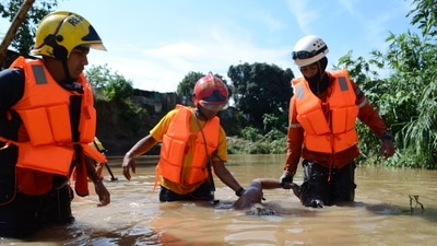 Venezuela Floods: Members of the Civil Protection hold a deceased man after a flood in Barquisimeto, Lara state, Venezuela. (AFP)