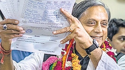 Former Union minister Shashi Tharoor shows his documents as he files his nomination papers for Congress party president election at AICC headquarters in New Delhi on Friday. (AP) (HT_PRINT) Former Union minister Shashi Tharoor shows his documents as he files his nomination papers for Congress party president election at AICC headquarters in New Delhi on Friday. (AP) (HT_PRINT)