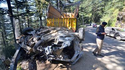 The mangled remains of the car after the apple-laden truck overturned on it at Hassan valley near Dhalli in Shimla district on Saturday. (Deepak Sansta/HT)