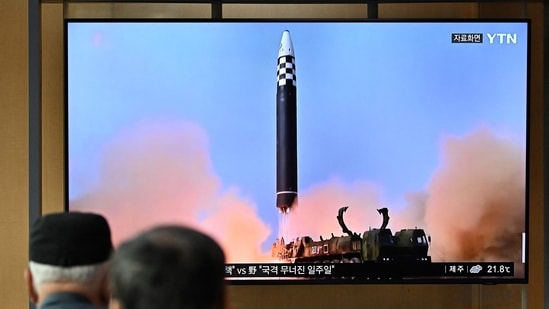 North Korea Nuclear Test: People watch a television screen showing a news broadcast with file footage of a North Korean missile test.(AFP File)