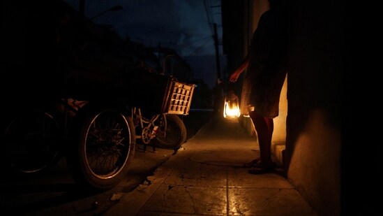 Hurricane Ian In Cuba: A street seller uses a lamp during a blackout in the aftermath of Hurricane Ian in Havana, Cuba.(Reuters)