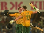 South African batter David Miller celebrates after scoring a century with teammate Quinton de Kock during the 2nd T20I between India and South Africa(PTI)