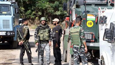 Security personnel stand guard at a site where an encounter took place between the security forces and militants, at the Baskuchan area, in Shopian on Sunday. Police on Sunday claimed to have killed a local Lashkar militant during an encounter in Shopian. (ANI)