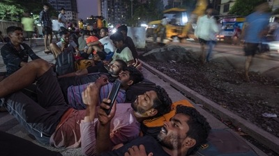 Candidates rest outside a school in Thane, on September 29. There is bonhomie no doubt, but also an air of exhaustion that pervades the camp. The travel to Mumbra is hectic, and most candidates were either catching a nap or giving one another foot massage before the all-important physical exam began, HT reported. (Satish Bate / HT Photo)