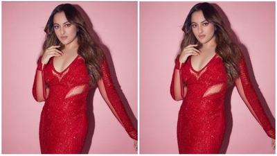 Sonakshi's crimson gown has a midriff-baring design, a plunging sweetheart neckline, and long sleeves. Her appearance is enhanced by the net detailing on the sleeves and midriff, which wonderfully complements her look. (Instagram/@aslisona) Sonakshi's crimson gown has a midriff-baring design, a plunging sweetheart neckline, and long sleeves. Her appearance is enhanced by the net detailing on the sleeves and midriff, which wonderfully complements her look. (Instagram/@aslisona)