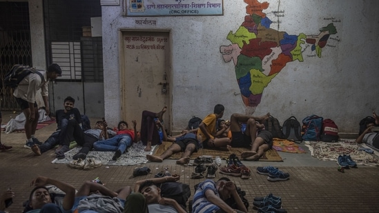 Candidates for recruitment under the Agnipath Scheme are seen resting at a school in Thane near Mumbai. The young men are billeted on the ground floor of a municipal school campus but there’s not enough space for all of them, so many of them have colonized the under-construction road outside where they sleep without any sheets.&nbsp;(Satish Bate / HT Photo)