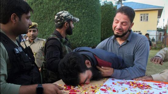 Relatives mourn near the mortal remains of slain policeman Javid Ahmad Dar after militants attacked a security forces team in Pulwama district on Sunday. A policeman was killed and a CRPF personnel injured in the attack. (PTI)