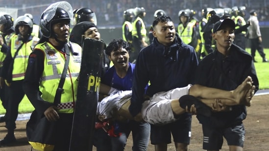 At least 129 people killed after stampede at football stadium in