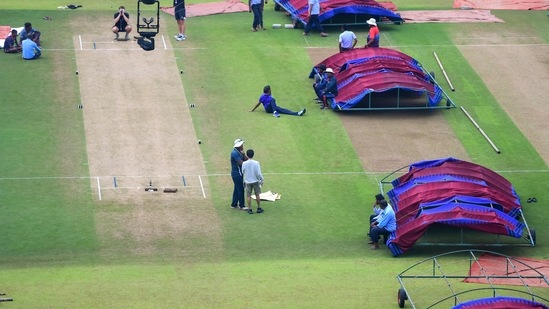 Groundsmen dry the playing field after rains at Vidarbha Cricket Association Stadium (PTI)