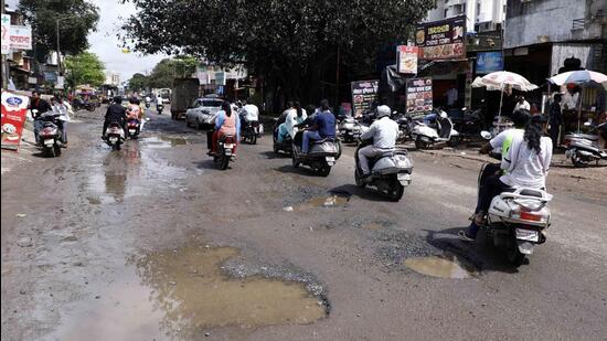 The potholes on the road should be filled and paved before the monsoon, and most importantly the maintenance of the drainage and other pipelines should be done by the end of June every year, say readers. (HT FILE PHOTO)