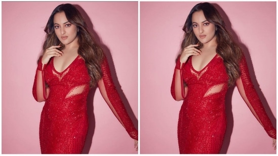 Sonakshi's crimson gown has a midriff-baring design, a plunging sweetheart neckline, and long sleeves. Her appearance is enhanced by the net detailing on the sleeves and midriff, which wonderfully complements her look.(Instagram/@aslisona)