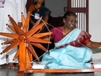 President Droupadi Murmu spins a charkha at the Ashram.(@rashtrapatibhvn) President Droupadi Murmu spins a charkha at the Ashram.(@rashtrapatibhvn)