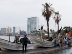 Hurricane Orlene In Mexico: A man walks past boats being stored out of the water on the seafront as Hurricane Orlene approaches Mexico.