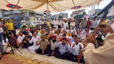 BJP workers and party leaders holding a protest at BR Ambedkar Chowk in Jalandhar on Monday. (HT photo)