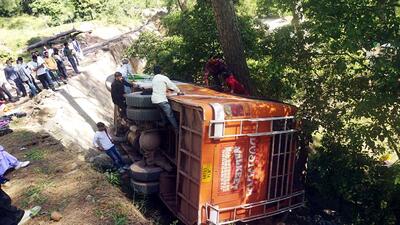 People gather near a passenger bus after it overturned, in Udhampur on Monday. (ANI)