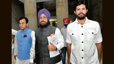 LoP Partap Singh Bajwa and Punjab Congress chief Amarinder Singh Raja Warring walk out of the House with other party members on Monday. (Ravi Kumar/HT) LoP Partap Singh Bajwa and Punjab Congress chief Amarinder Singh Raja Warring walk out of the House with other party members on Monday. (Ravi Kumar/HT)