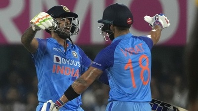 Suryakumar Yadav, left, celebrates scoring runs with batting partner Virat Kohli during the second T20 cricket match between India and South Africa in Guwahati (AP)